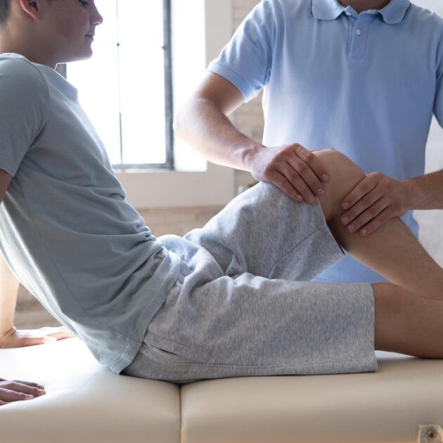 close-up-physiotherapist-massaging-patient-min